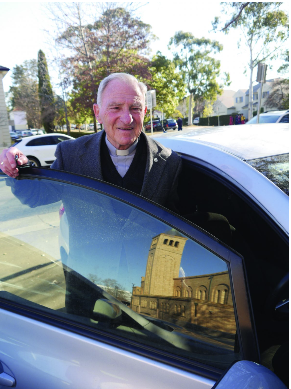 man standing in car door